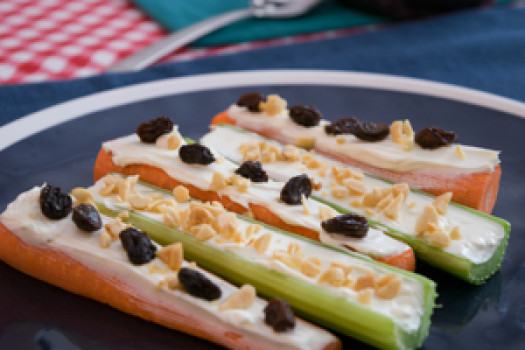 Carrots and Celery topped with yogurt, raisins and peanuts.