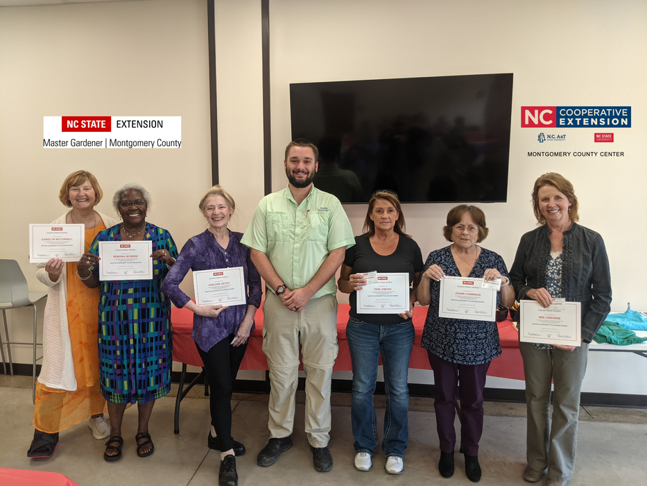 Seven people holding Master Gardener certificates at NC State Cooperative Extension, Montgomery County
