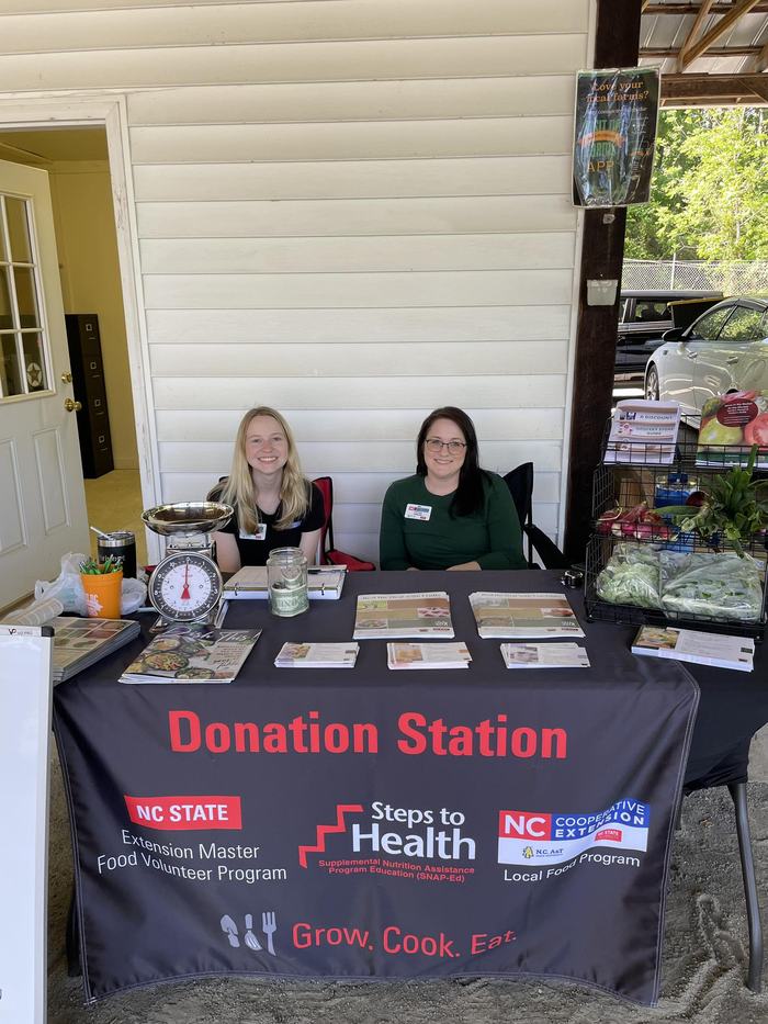 Chelsea Johnson and Kellee Payne sitting at the Yadkin County Donation Station