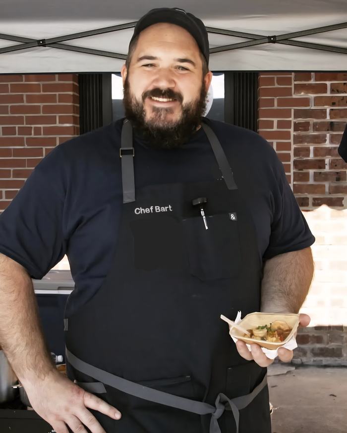 Bearded man in apron labeled "Chef Bart" holding a small bowl of food.
