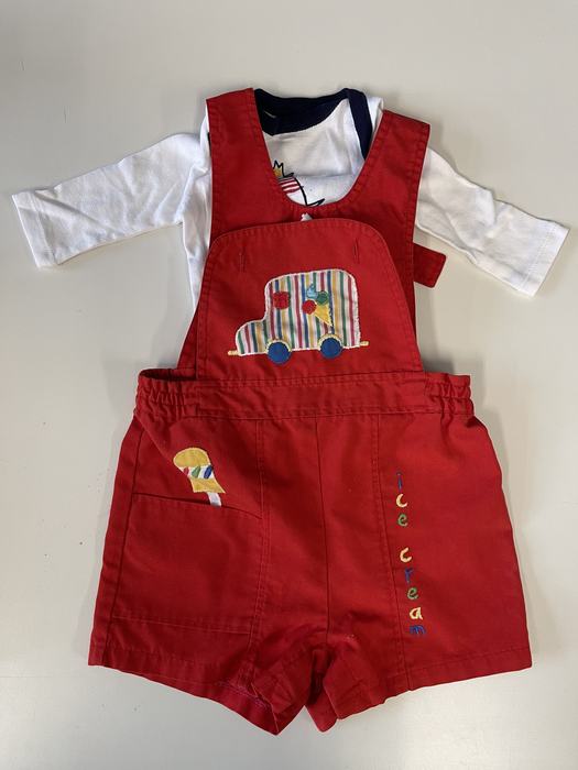 A white shirt with red overalls for a toddler.