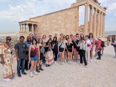 Large tour group posing in front of the Erechtheion temple on the Acropolis