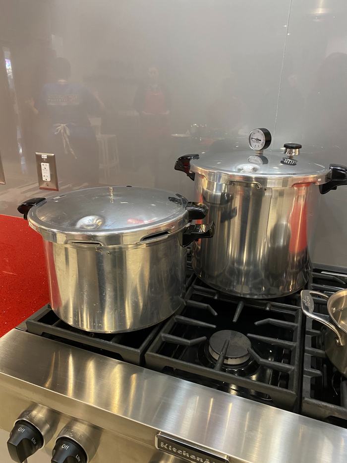 Two pressure canners on stovetop