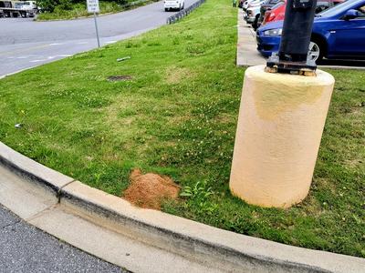 red mound beside a concrete pole holder