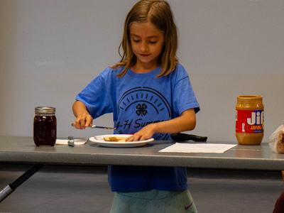 4-H youth presenting how to make a peanut butter and jelly sandwich at county activity day 2025 - provided by Megan Sweeney