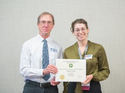 Man presenting a certificate to a woman