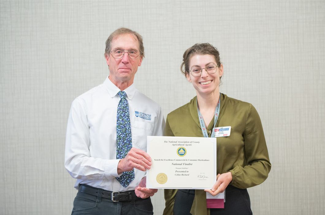 Man presenting a certificate to a woman