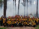 Group photo of Fire Week participants in front of a prescribed burn at North Carolina State Parks.