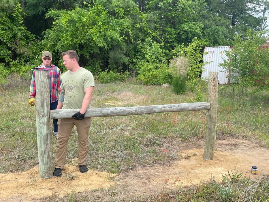 People learning to build a fence