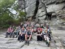 Picture of a group of students sitting on the side of a mountain