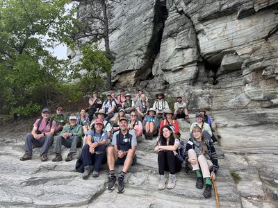 Picture of a group of students sitting on the side of a mountain
