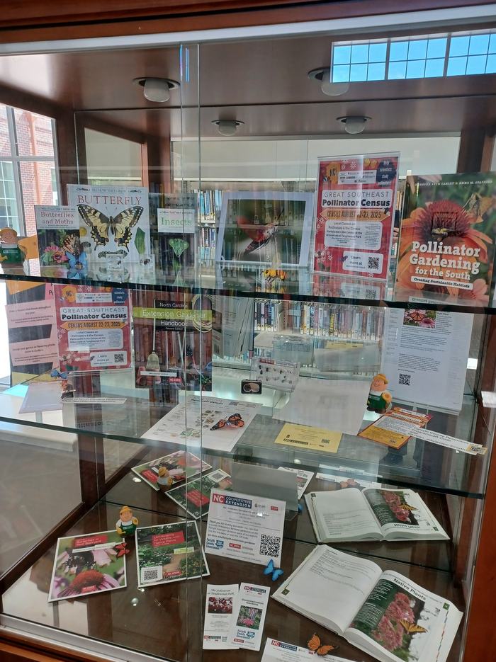 Image of display about Pollinators. Display includes book recommendations, flyers about the Great Southeast Pollinator Census, and other resources. Display is housed at the Paddison Memorial Branch Library in Kernersville.
