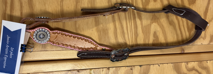 Decorative leather horse headstall with concho and clipped card reading "1st place Junior Artistic Expression"