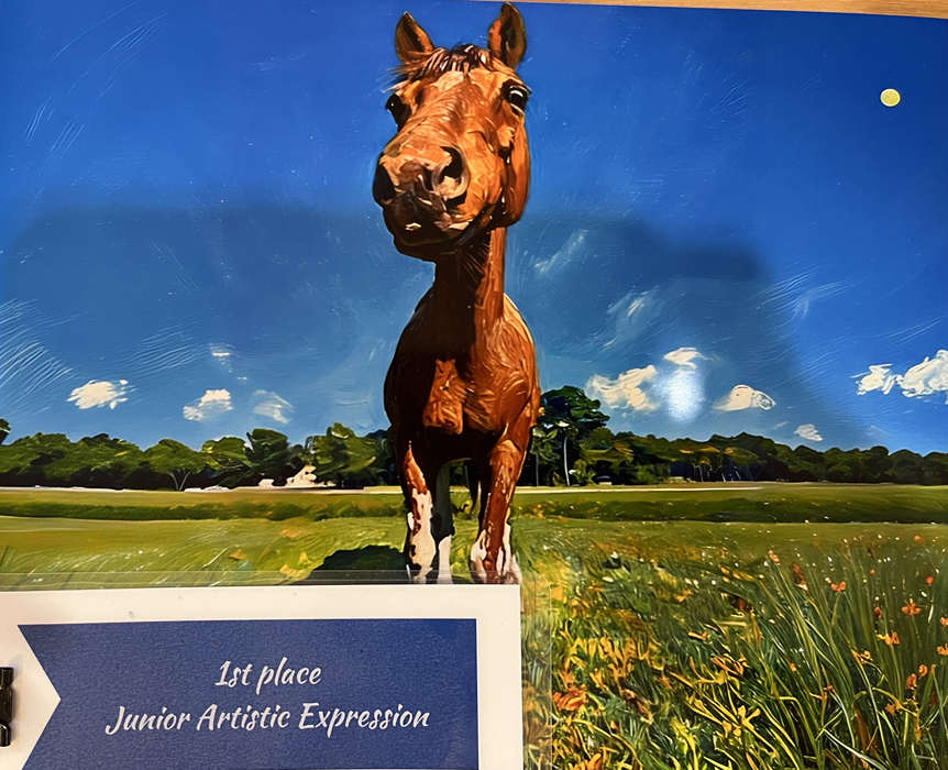 Brown horse standing in a field under blue sky; sign reads "1st place Junior Artistic Expression"