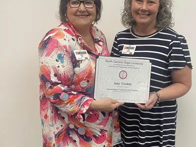 Picture of Sandy Hall presenting certificate to Amy Twiddy