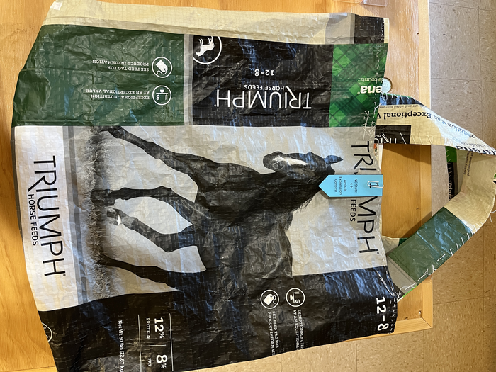 Triumph Horse Feeds bag with horse image and ribbon "NC State 4‑H Artistic Expression Contest"