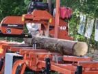 A mobile mill processing a log.