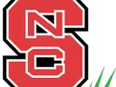 Red block "S" with interlocked white "NC" inside, three green grass blades at lower right
