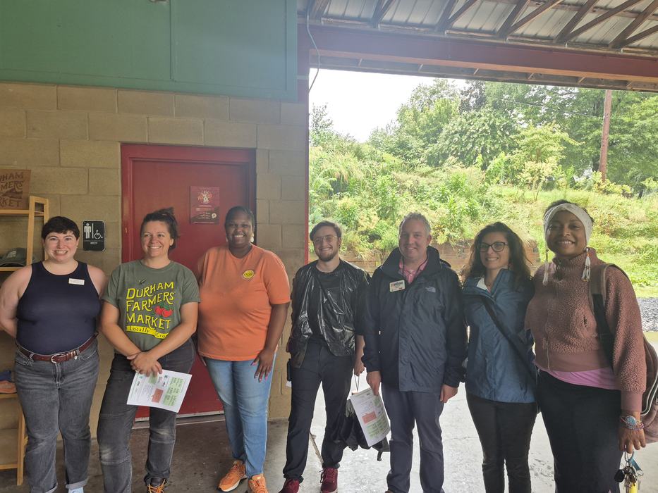 Jonathon posing with group at Durham Farmers' Market. 