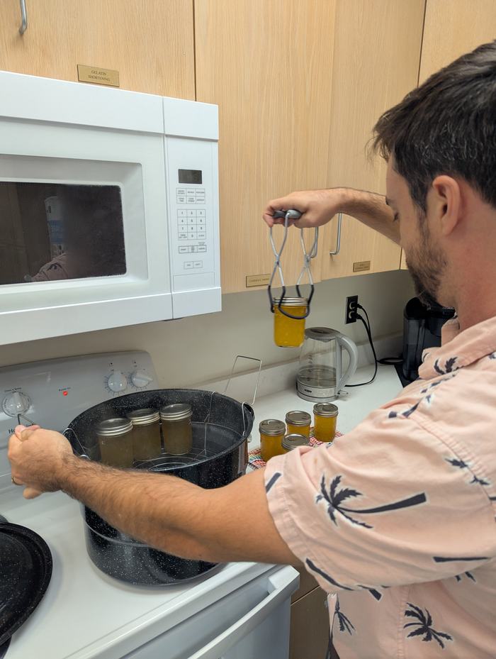 A man places cans in a pressure canner.
