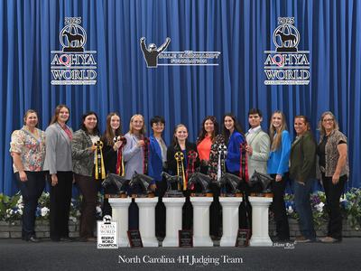 North Carolina 4H judging team standing with trophies and ribbons at AQHYA World 2025