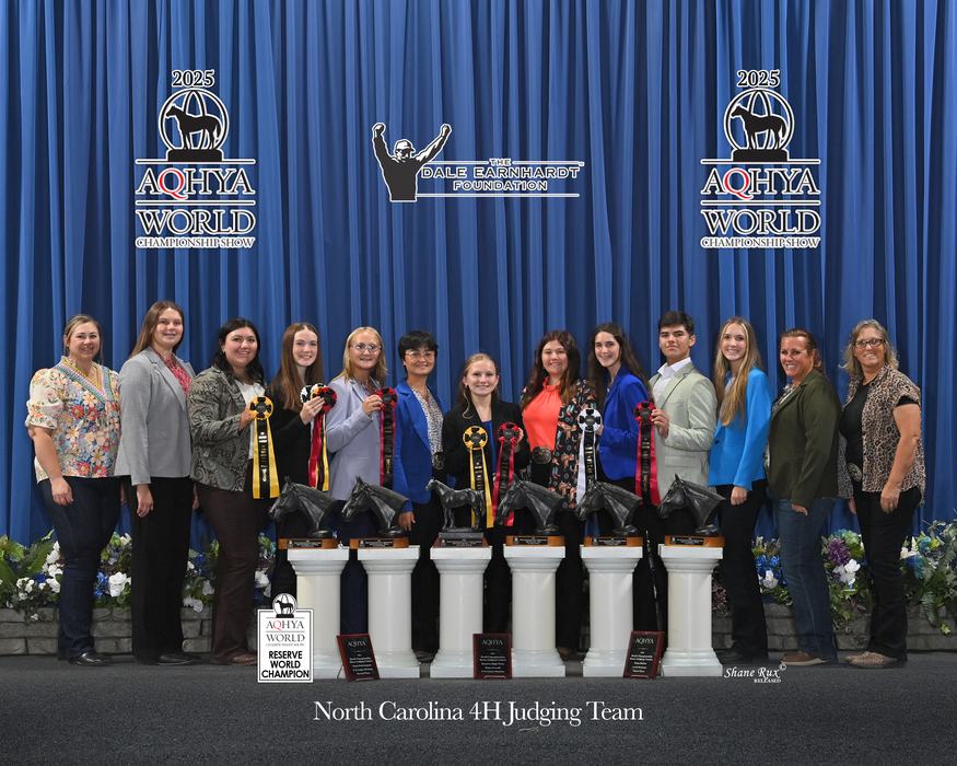 North Carolina 4H judging team standing with trophies and ribbons at AQHYA World 2025