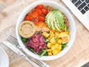 bowl with avacado tomatoes lettuce and onions