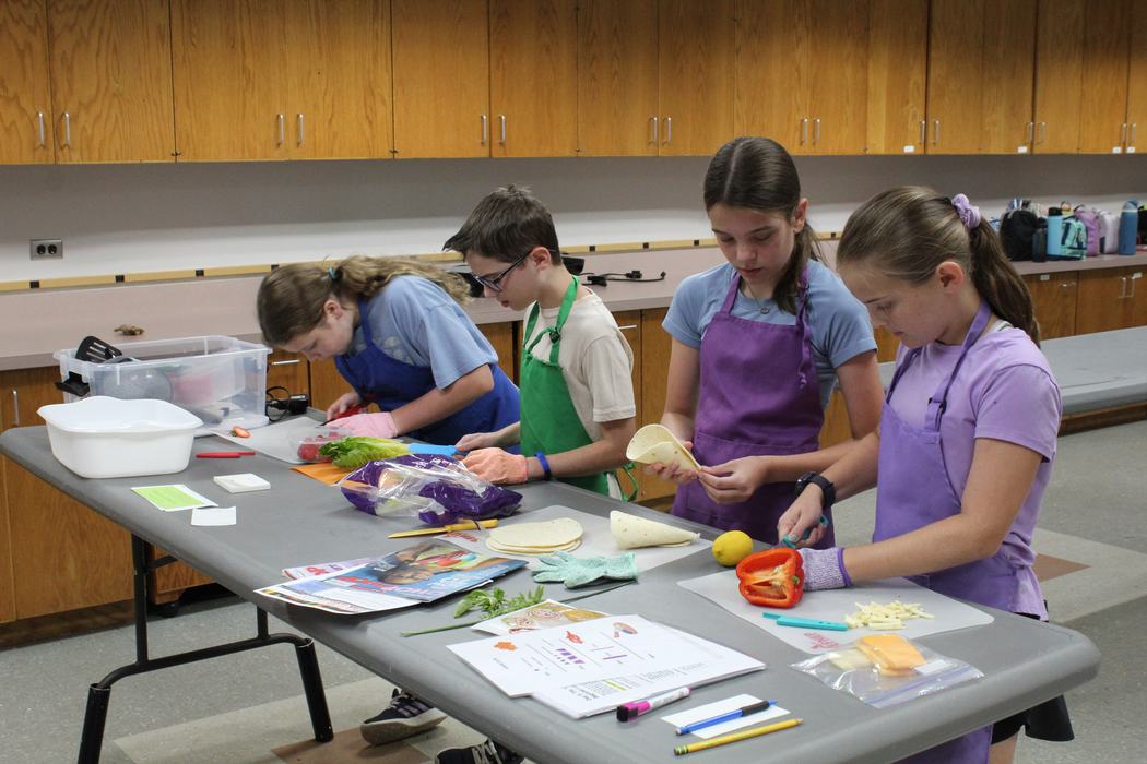 Students participating in a "chopped-style" cooking competition. 