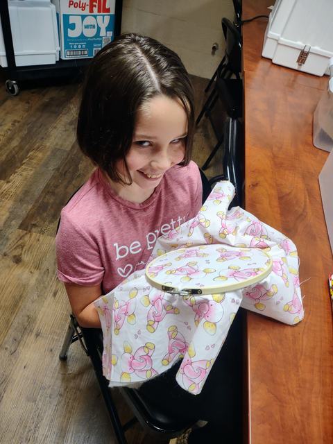 Girl hand stitching.