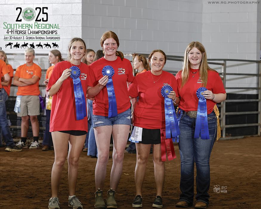Four girls in red shirts holding blue ribbons at 2025 Southern Regional 4-H Horse Championships