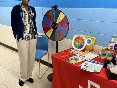 Keilah standing near table with promotional items