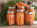 Home canned carrots with raw carrots on top of the cans