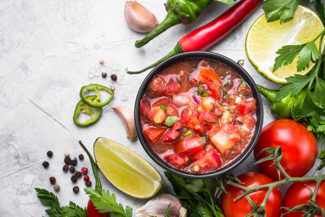 Bowl of fresh tomato salsa with lime, garlic, peppers, and tomatoes