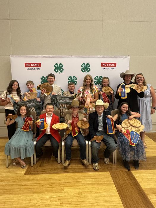 Youths posing with awards from the Youth Livestock Show.