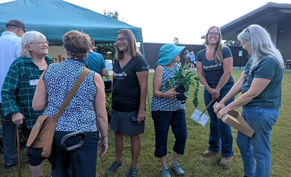 Rachel talks plants with some of her customers.