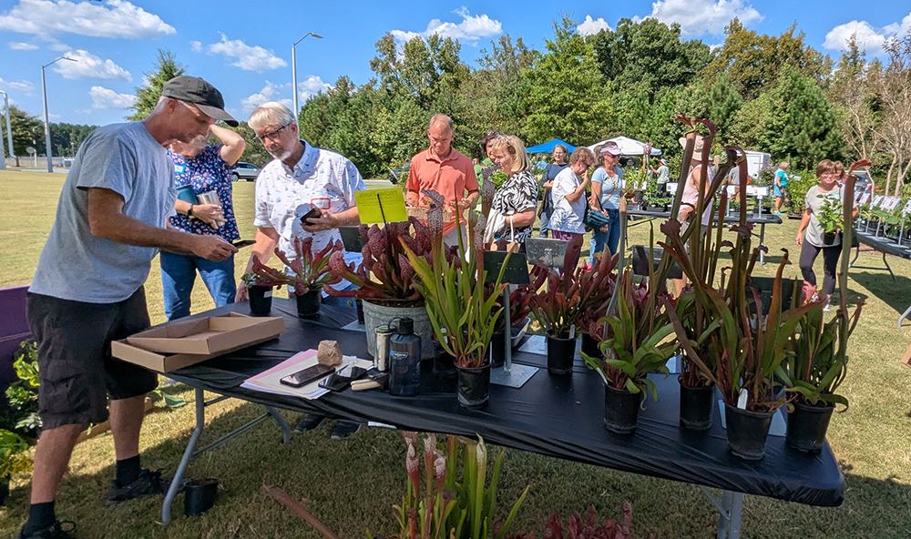 Grower Alistair Glen tends to customers at the Growing Wild Nursery booth.