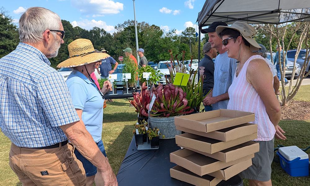 Alistair and Charlotte wait on customers at the Growing Wild Nursery booth.
