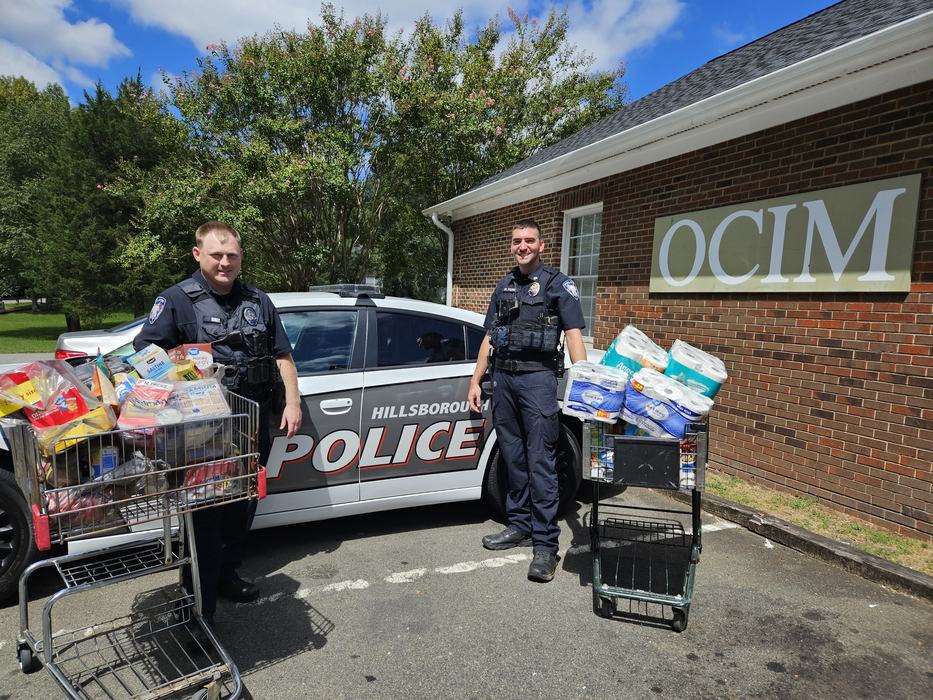 Hillsborough Police Officers delivering donations to OCIM.