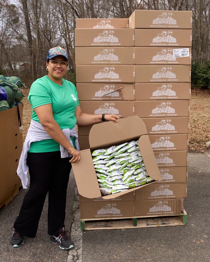 Volunteer showing open box of chips they are distributing at a PORCH Hillsborough event.