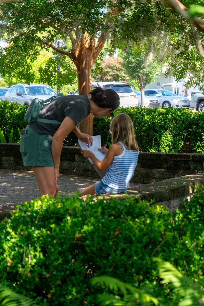 Family working on drawing together during Draw and Discover session.