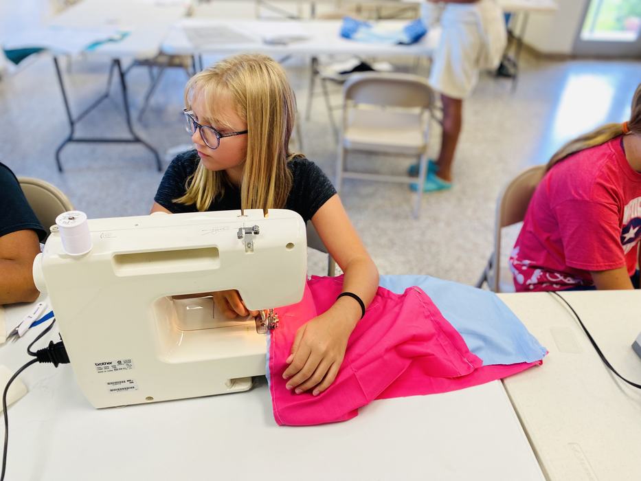 Pamlico County 4-H member sewing a bag during Sew Much Fun program.