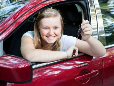 Girl in a car holding keys