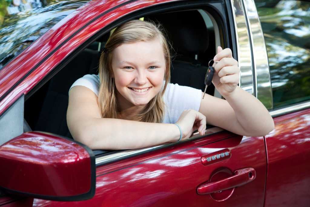 Girl in a car holding keys