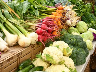 Assorted market vegetables including garlic, radishes, beets, cauliflower, and broccoli