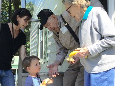 Volunteers delivering food to Meals on Wheels senior meals recipients at home.