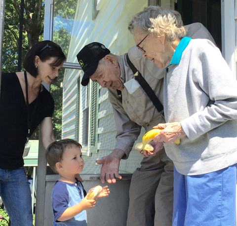 Volunteers delivering food to Meals on Wheels senior meals recipients at home.