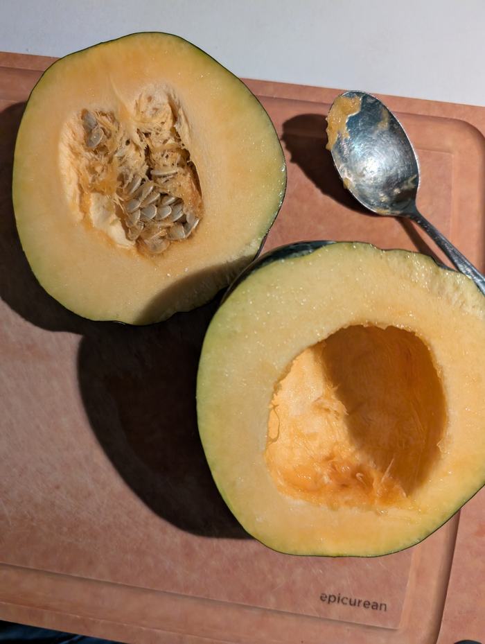 An acorn squash, partially cleaned.