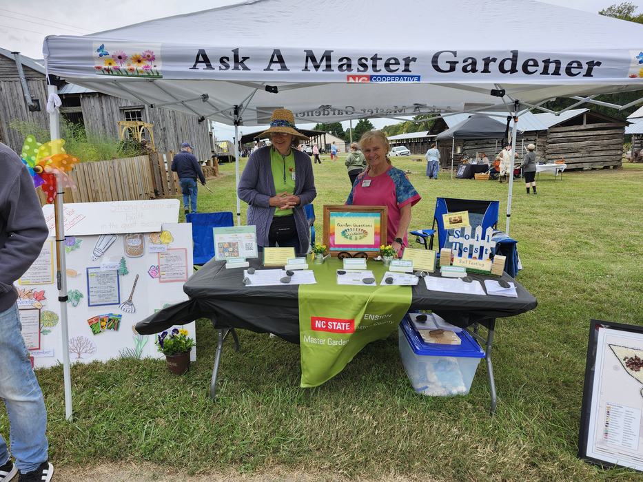 Extension Master Gardener Volunteers standing at a table.