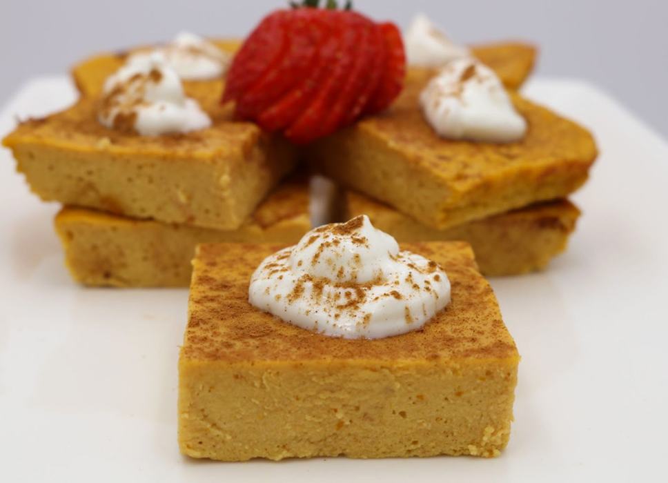 Baked pumpkin bars with whipped cream.