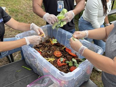 Staff making compost